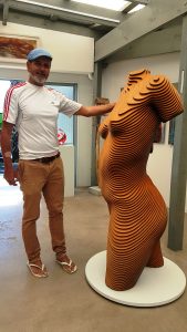 a large wooden sculpture of a female torso