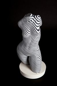 a black and white sculpture of a female torso